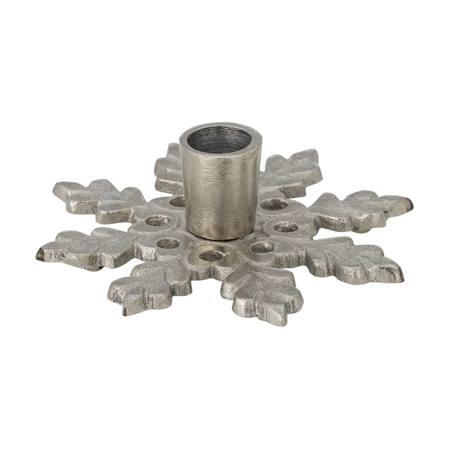 Kashi Snowflake Aluminium Christmas Candle Holder in silver, a flat star-shaped base with leaf-like arms and a single round taper cup at the centre, shown on a plain white background.