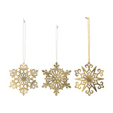 Mani Iron Christmas Tree Decorations Set of 3 in gold, three pierced metal snowflake ornaments with scrolled, leaf, and star designs, hung on cord against a white background.