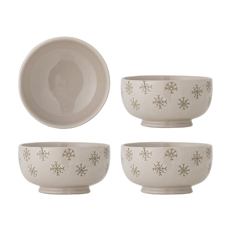 Set of four beige stoneware bowls, 13cm, with snowflake motifs around the exterior and plain interiors, shown from above and at an angle on a white background.