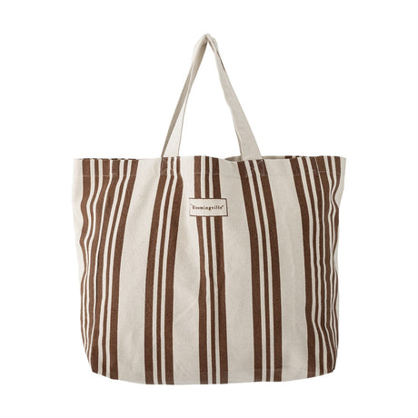 Trina Striped Cotton Shopping Bag in brown and natural vertical stripes, with twin fabric handles and a woven label, shown on a plain white background.
