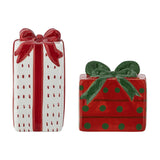 Marnia ceramic Christmas salt and pepper shakers shaped as gift boxes, one tall white parcel with red stripe and bow, one low red parcel with green dots and bow, on a white background.