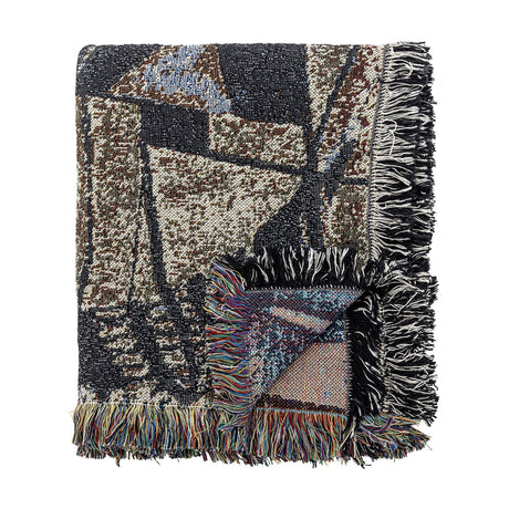 Rahul Cotton Throw in Multi, a folded woven cotton blanket with a bold abstract pattern in black, brown, cream and blue, finished with loose multicoloured fringe, shown on a white background.