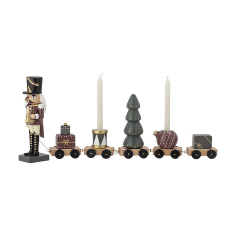 Vadim Christmas Decoration 18.5cm, a nutcracker soldier figure pulling five wooden wagons carrying a gift, drum, tree, bauble and candle holders, in multicoloured MDF and beech on a white background.