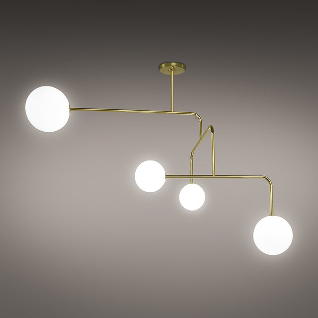 Lumorne 4 Light Glass Globe Chandelier in polished brass, with slanted metal rods at angled bends holding four varied-size opal glass globes, shown against a plain grey background.