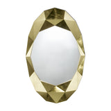Oval mirror set within a chunky faceted surround finished in hand applied gold leaf, an irregular outline on a plain background.