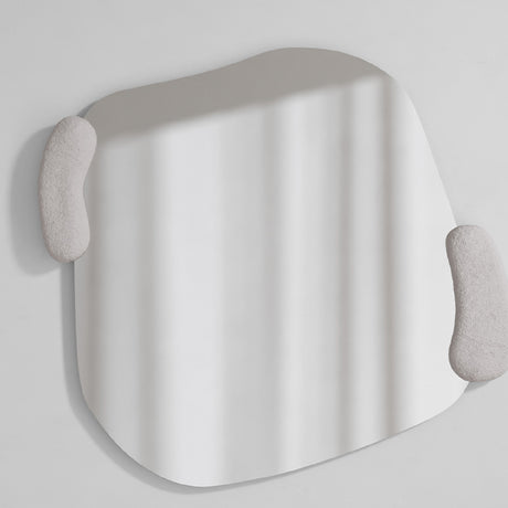 Irregular sculpted wall mirror with two moulded white forms held against its edge, the glass curving between them.