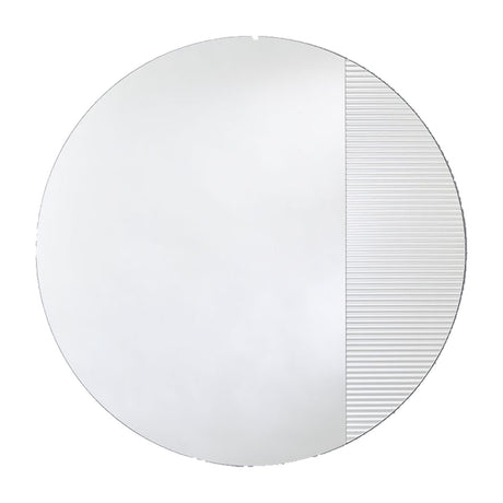 Round frameless mirror, one part plain and one part vertically fluted so the reflection breaks into bands, on a plain background.
