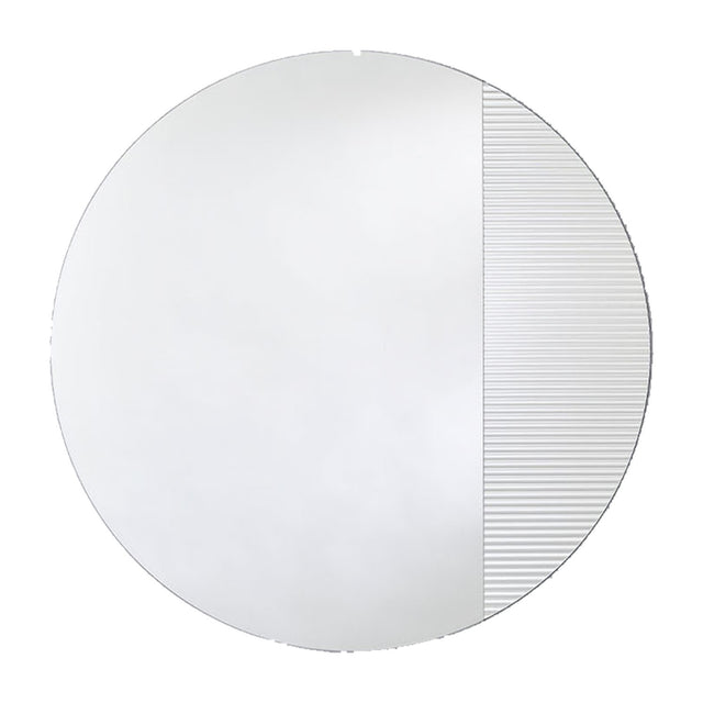 Round frameless mirror, one part plain and one part vertically fluted so the reflection breaks into bands, on a plain background.