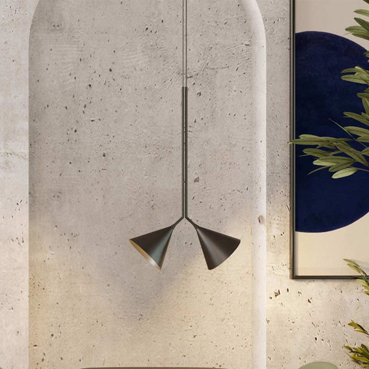 Rubi Duo Cone Pendant light with two angled cone shades in matt black with gold interior, hung from a slim rod against a textured concrete archway.