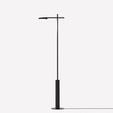 Rafaela LED Disc Floor Lamp in matt black, slim iron upright on a cylindrical base with a horizontal arm holding a round LED disc head, shown on a plain light background.