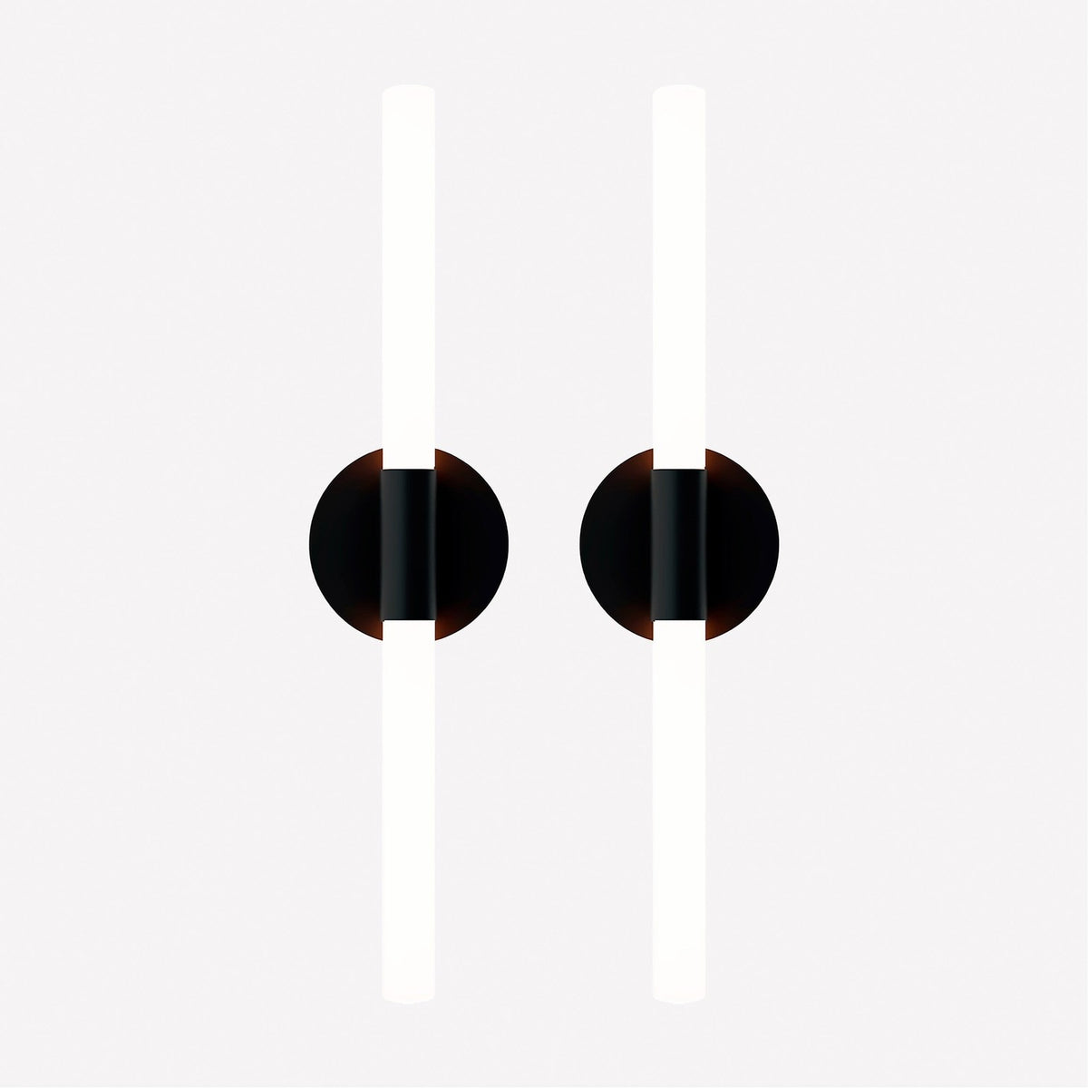 Pair of Roos LED Cylinder Disc Wall Lights in matt black, each with a round disc and vertical sandblasted acrylic tube lit warm white, on a plain light background.