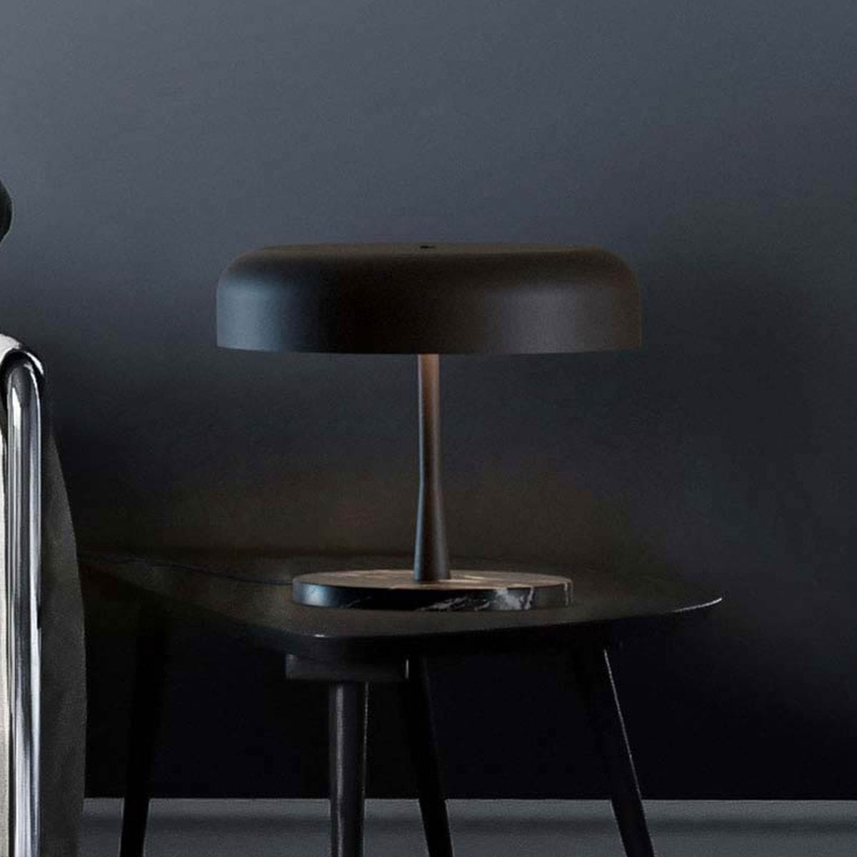 Rea 3 Light Dome Mushroom Table Lamp with wide matt black dome shade and slim stem on a dark marble base, shown on a table in a dark-toned room setting.