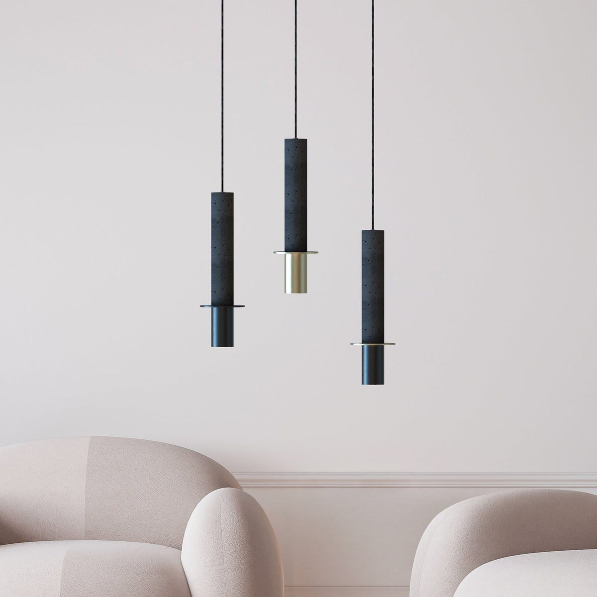 Rita Disc Pendant lights in black concrete with cylindrical columns, iron heads and flat discs, shown in brass and black finishes above armchairs.