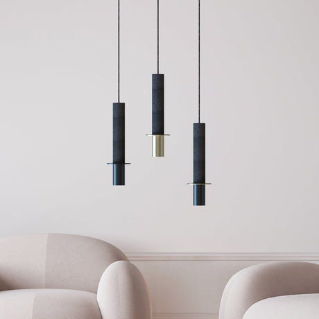 Rita Disc Pendant lights in black concrete with cylindrical columns, iron heads and flat discs, shown in brass and black finishes above armchairs.