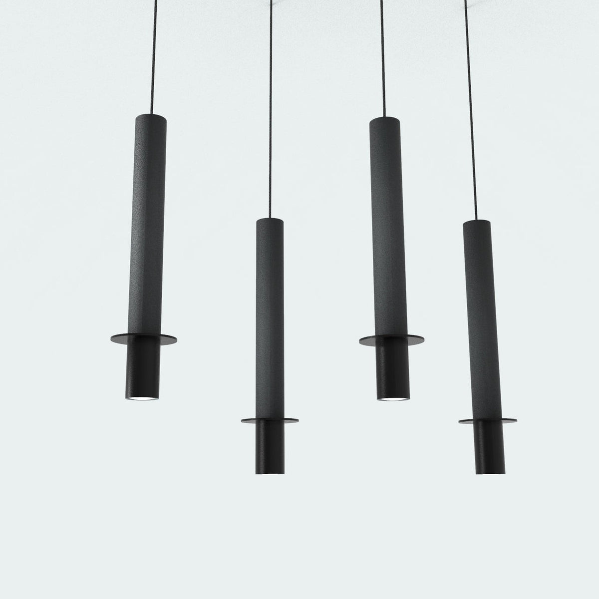 Rita Disc Pendant with Concrete Structure in black: four slim cylindrical pendants with iron heads and flat discs, hung at staggered heights on thin cables against a plain light background.