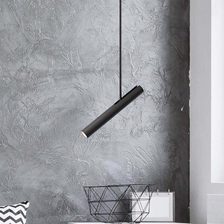 Rhoda Adjustable Linear Pendant Light in matt black iron, slim angled tube shade with GU10 lamp, hung against a grey textured wall above a wire basket.