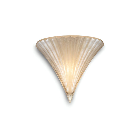 The Spring Small Glass Wall Light in Gold offers a fan-shaped, ribbed glass design that embodies modern luxury. Its seashell-like silhouette with a pointed bottom emits a warm glow, highlighting its intricate texture. Ideal for those who value both elegance and practicality in compact lighting solutions.