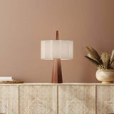 Rain Scalloped Fabric Table Lamp in Chestnut with tapered wood base, central spire and white scalloped fabric shade, shown on a sideboard in a warm-toned room.