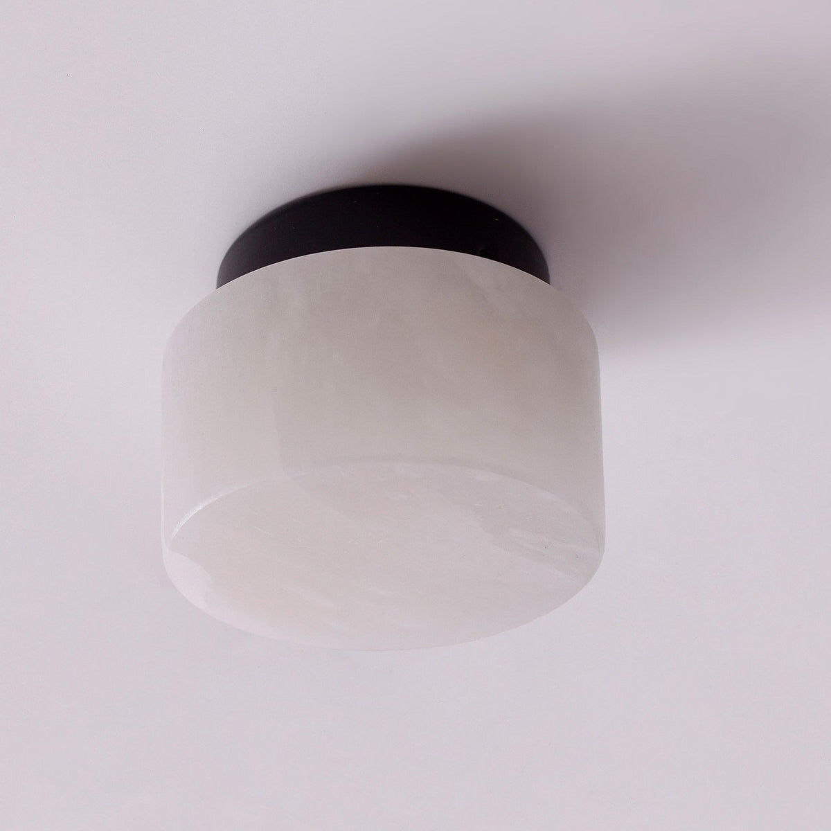 Rock LED Alabaster Drum Flush ceiling light with a black aluminium base, shown against a plain white background.