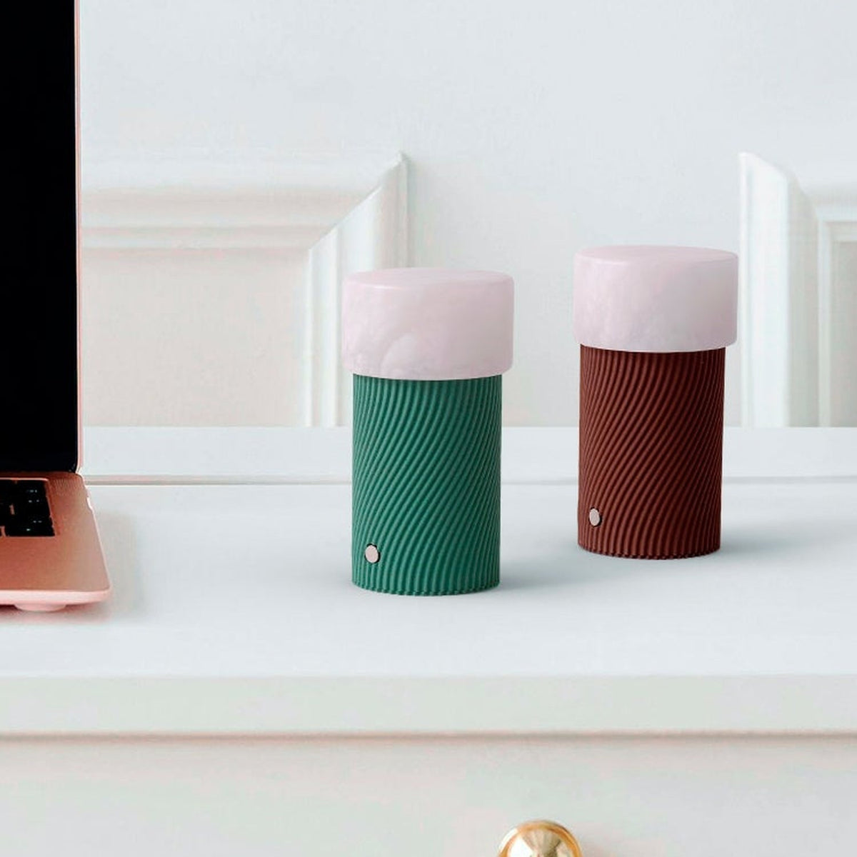 Rizzo LED Alabaster Rechargeable Table Lamp in Willow, with ribbed green cylindrical base and pink alabaster shade, shown on a desk beside a matching terracotta version.