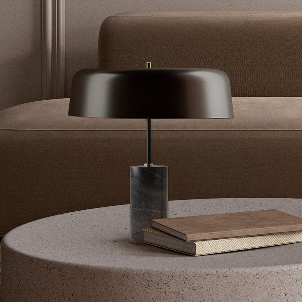 Romina Dome Mushroom Table Lamp with matt black aluminium dome shade on dark marble base, shown on a side table beside stacked books in a living room setting.