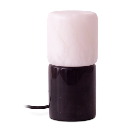 Rock Cylinder Alabaster Table Lamp with a pale alabaster cylindrical shade stacked on a glossy black marble base, fabric cord visible, set on a plain white background.