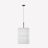 Rania cylinder fabric pendant light with white cream shade and fine seam grid, suspended from a matt black iron fitting on a textile cable, plain background.