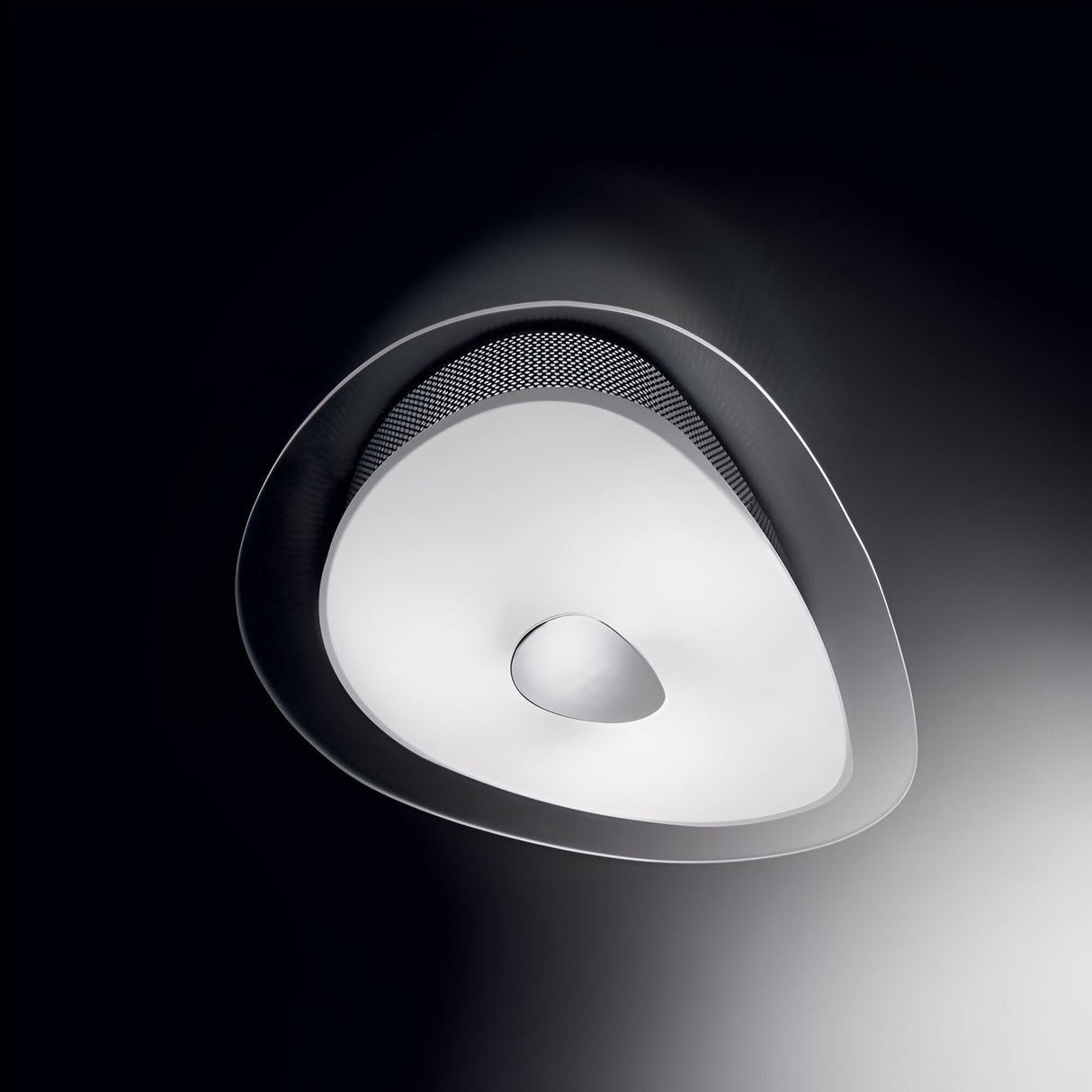 The Azure 3 Light Ceiling & Wall Light - White is a contemporary lighting fixture with an abstract, asymmetrical design. It includes a dimmable feature and showcases a white surface with a central circular indentation, encased in a metallic frame against a dark background.