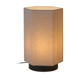 Roxi Fabric Floor Lamp with hexagonal natural fibre shade, lit from within, set on a round dark brown base against a plain white background.