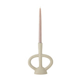 Ramina resin candle holder in beige, with a slender stem, flared foot, and two looped arms, holding a pink taper candle on a plain white background.