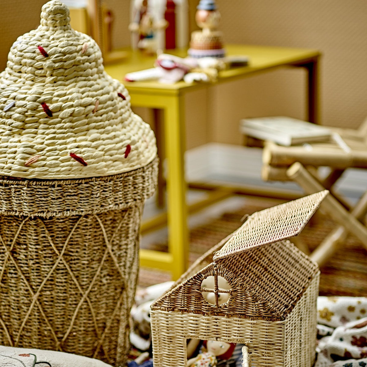 Cillie Seagrass Basket with Lid 72cm in Natural, shaped like a soft-serve cone with a woven criss-cross base and stepped swirl lid, shown beside a small wicker house box.