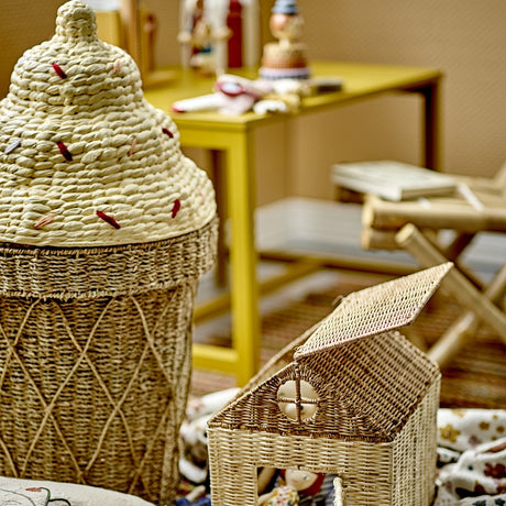Cillie Seagrass Basket with Lid 72cm in Natural, shaped like a soft-serve cone with a woven criss-cross base and stepped swirl lid, shown beside a small wicker house box.