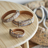 Imola Cotton Dog Collars Set of 3 in brown, graduated sizes with woven patterned fabric over leather, brass buckles and D-rings, shown on a wooden table.