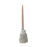 Souri Stoneware Candle Holder in grey, gourd-shaped with a bubbled drip glaze and looped side detail, holding a tall taper candle against a plain white background.