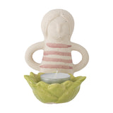 Clarabel Stoneware Tealight Holder in multi, a cream figure with pink striped top and arm loops standing behind a green scalloped cup holding a tealight, on a white background.