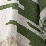 Haxby Throw in green, woven fabric with bold irregular stripes and knotted fringe edge, shown in close-up detail.