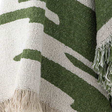 Haxby Throw in green, woven fabric with bold irregular stripes and knotted fringe edge, shown in close-up detail.