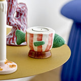 Codia Fish Stoneware Tealight & Candle Holder in multicoloured ceramic, shaped like a fish with green head and tail, red and white striped body, on a footed base.