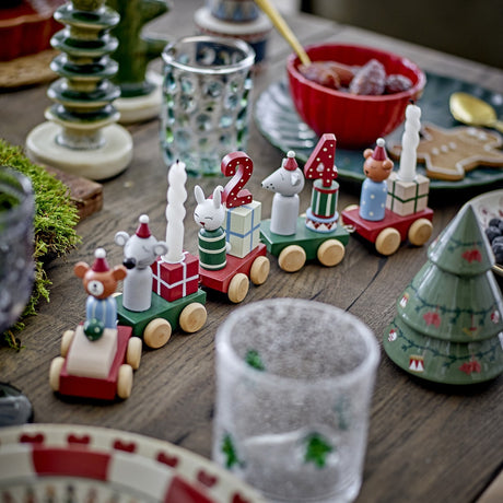 Junaid Christmas Countdown Train wooden decoration with colourful carriages carrying bear, mice and rabbit figures, candles and number blocks, displayed on a table with festive décor.