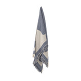 Ethan Cotton Throw in blue and cream, woven in a bold two-tone geometric pattern with fringed edges, hanging against a plain white background.
