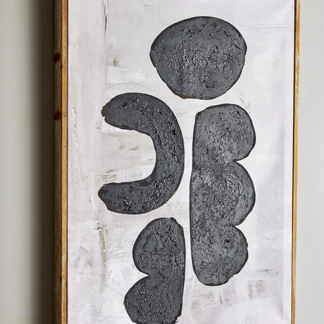 Comma Wooden Framed Print in Black, featuring four textured black forms—a round pebble, a bracket curve, and two stacked lobes—on a brushed white canvas with a slim firwood frame.
