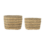 Indra Striped Water Hyacinth Baskets Set of 2 in natural, oval woven storage baskets with alternating flat and twisted bands and a twisted rope rim, shown on a plain white background.