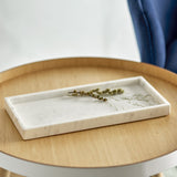 Majsa Marble Tray 38x18cm in white, a rectangular raised-rim tray with soft grey veining, shown on a wooden side table with a sprig of greenery.