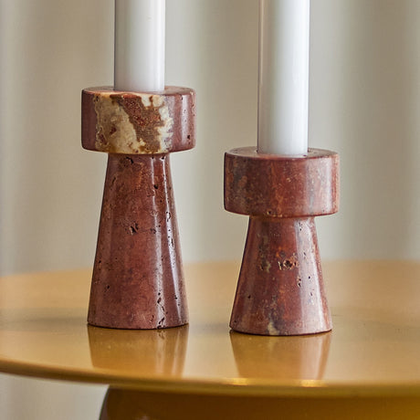 Anneli Travertine Candle Holders Set of 2 in brown, two polished stone holders with wide tapered bases and round collars at different heights, holding white candles on a gold table.