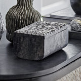 Nubia Soapstone Storage Box with Lid in grey, rectangular with a textured raised-square lid, shown on a dark table beside a ribbed vase.