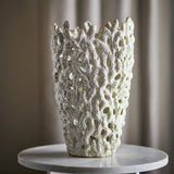Eunice Stoneware Vase 37cm in White, with heavily textured, pierced coral-like walls and an uneven rim, displayed on a round marble side table.