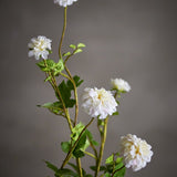 Artificial chrysanthemum stem, 101cm, with five white layered flowerheads and green leaves on branching stems, shown against a plain grey background.