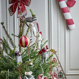 Peo Star wool Christmas tree decoration featuring white mice hanging in a chain on a pine tree, styled with a red striped bauble and candy cane details.