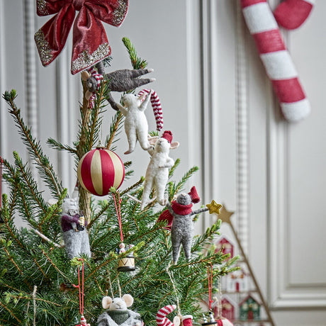 Peo Star wool Christmas tree decoration featuring white mice hanging in a chain on a pine tree, styled with a red striped bauble and candy cane details.
