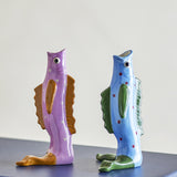 Mako Fish Stoneware Vases, 19cm, set of 2, upright fish-shaped with open-mouth necks, ridged fins and tail-fin feet, in hand-painted purple and blue dotted finishes on a plain background.